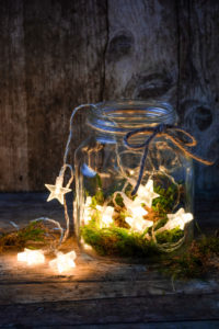 Christmassy still life with chain of lights in a rustic glass Christmassy still life with chain of lights in a rustic glass